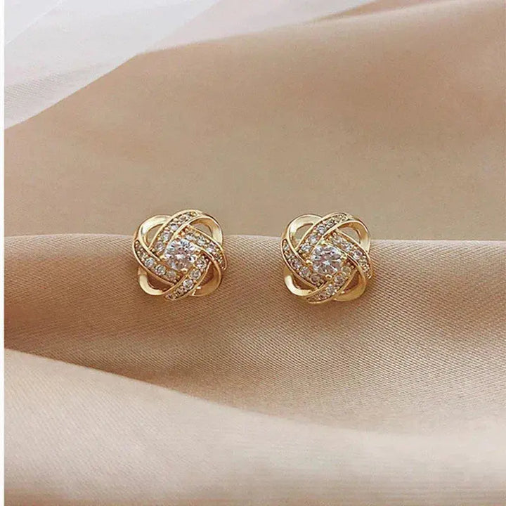 Crystal earrings with golden spiral design