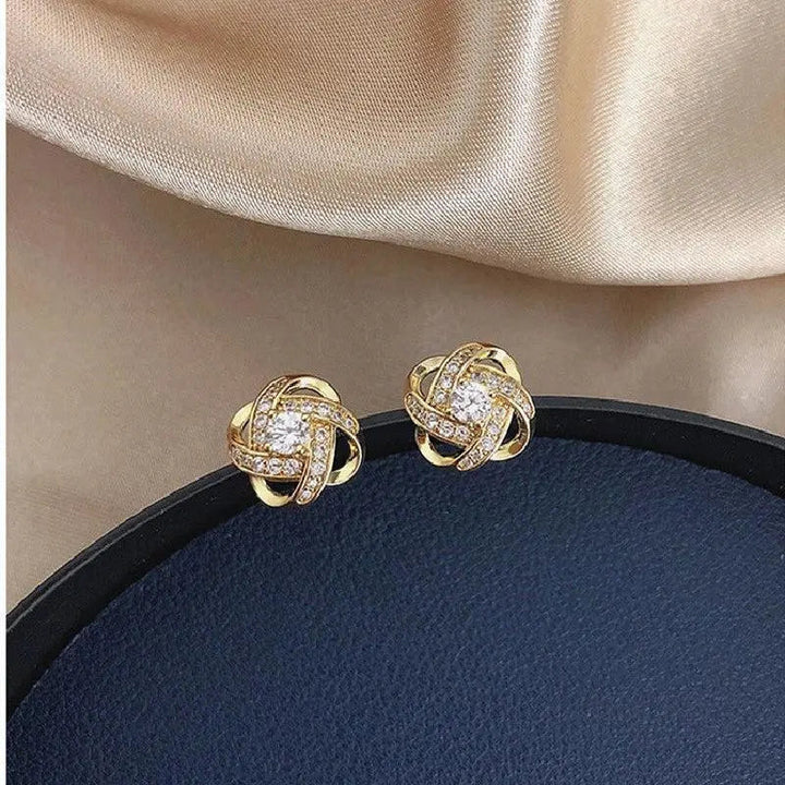 Crystal earrings with golden spiral design